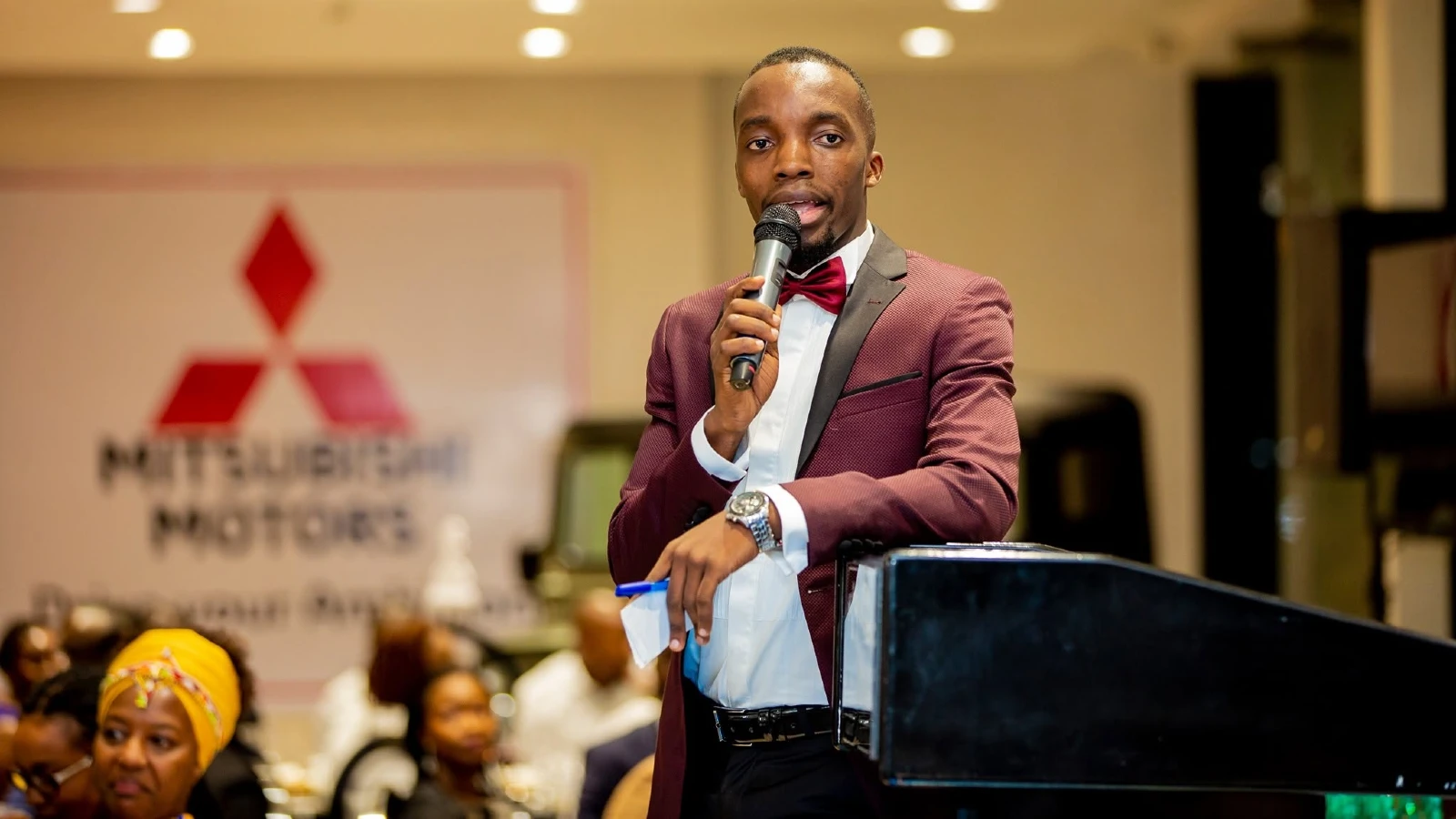 Dr. King’ori speaking with a microphone at an event